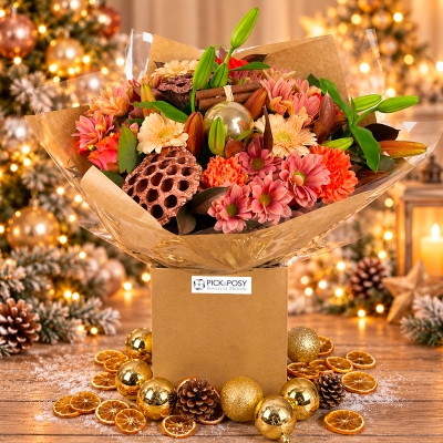  Rustic Copper & Cinnamon Christmas bouquet by PICKaPOSY, featuring peach, apricot and copper-tones with festive greenery and natural kraft-style wrapping.