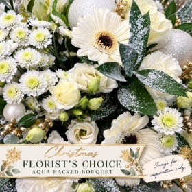 Christmas Florist's Choice Aqua Packed Bouquet by PICKaPOSY, featuring a festive close-up of white gerberas, cream lisianthus, white chrysanthemums and snowy foliage with Christmas decorations. Image for inspiration only.